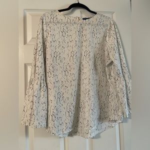 White bell sleeve blouse with black and lilac pattern.